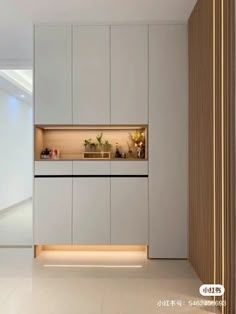 an empty room with white cabinets and plants