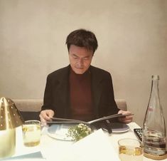 a man sitting at a table reading a book