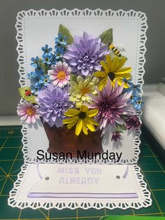 a greeting card with flowers in a vase