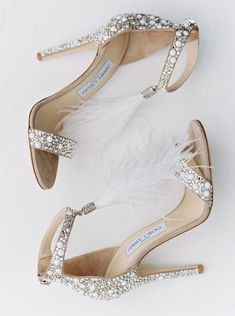 the brides shoes are adorned with feathers and crystal stones, which were accented with swaroes