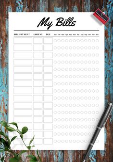 a printable my bills checklist on a wooden table with a pen and pencil