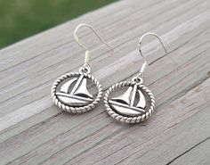 "These sailboat earrings are adorable.  They are a silver color and are on sterling silver hooks  Each set will be sent to you in a gift box. Total length is 1 1/4\" inches. Width is 5/8\". These make awesome gifts! Especially anniversaries, weddings, birthdays, holidays, and bridesmaid gifts." Sailboat Earrings, Silver Ocean-inspired Earrings For Gifts, Sterling Silver Starfish-shaped Earrings With Charm, Memory Locket, Stone Bracelet, Earring Gifts, Locket, Silver Color, Bridesmaid Gifts