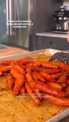 a person is grating carrots on a tray