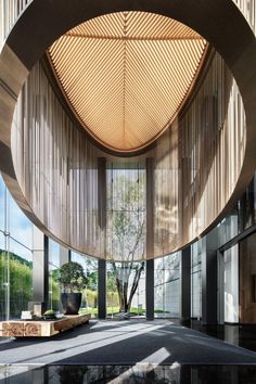 the inside of a building with large windows and wooden slats on the ceiling,