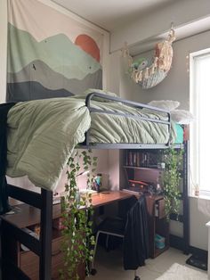 a bedroom with a bed, desk and hanging plant