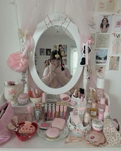 there is a vanity with pink accessories on the counter and a mirror in the corner