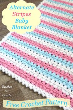 a crocheted baby blanket with pink, blue and white stripes on the bottom