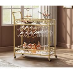 a gold bar cart filled with bottles and glasses