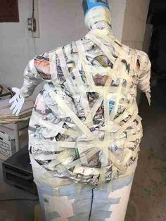 a man made out of newspapers and newspaper strips