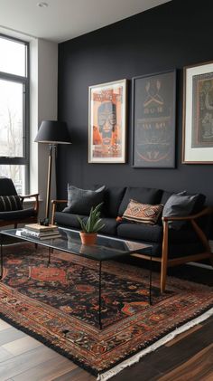 a living room with black walls and wooden flooring, artwork on the wall above the couch