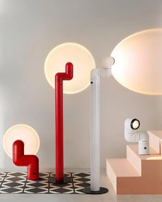 two red and white poles are on the floor in front of some circular lights,