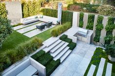 an outdoor living area with grass and plants on the walls, stairs to the roof