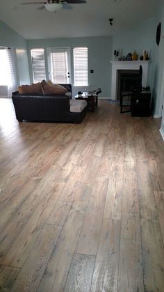 an empty living room with hard wood floors