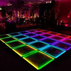 an illuminated dance floor in a dark room