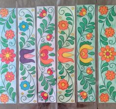 four different colored flowers and leaves painted on paper