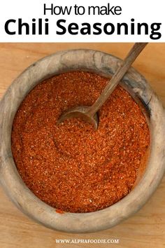 a bowl filled with chili seasoning on top of a wooden table