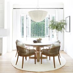 a dining room table with four chairs around it