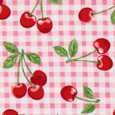 cherries on a checkered tablecloth with green leaves and pink gingham