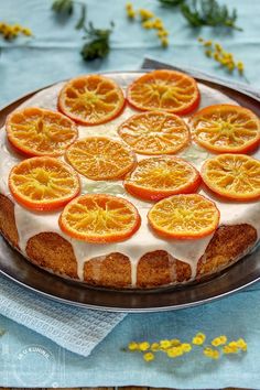 a cake with orange slices on it sitting on a plate