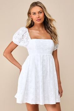 If we seem a little distracted, it's only because we were fantasizing about prancing through a meadow wearing the Lulus Fit to Frolic White Eyelet Lace Puff Sleeve Babydoll Dress! This embroidered eyelet lace dress is here to serve up all those free-spirited daydreams with its square neckline, short puffy sleeves (with elastic at the shoulders and cuffs), and babydoll silhouette. Mini hem wears well with bare feet and a basket of flowers! Hidden back zipper/clasp. Fit: This garment fits true to Puff Short Sleeve Dress, Cute White Dress Aesthetic, White Lace Dress With Short Sleeves, White Fancy Dresses, Homecoming Dress Modest, White Dress Aesthetic, Puff Sleeve Babydoll Dress, White Babydoll Dress