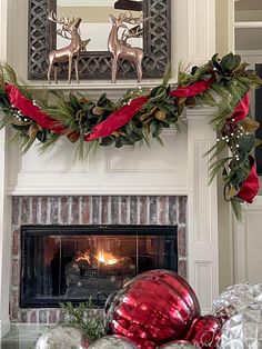 a fireplace decorated for christmas with red and silver ornaments