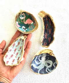 three different types of brooches are being held by someone's hand