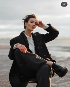 a woman sitting on top of a wooden chair