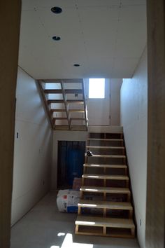 an empty room with stairs leading up to the second floor