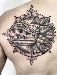 a man's chest with a tattoo design on it