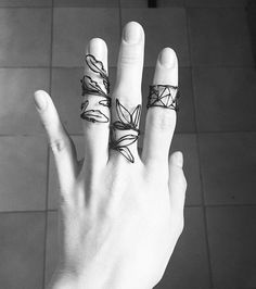 a person's hand with three rings on it