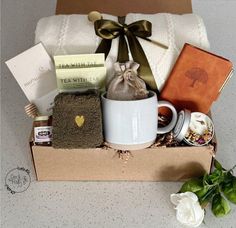 a gift box with tea, cookies and other items for someone's special occasion