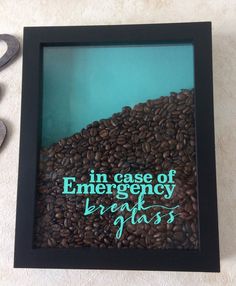 there is a frame with some coffee beans in it and scissors on the floor next to it