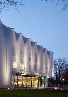 a large white building with lots of windows on it's side at night time