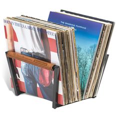 a stack of vinyl records sitting next to each other on top of a wooden stand