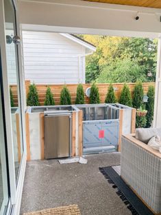 an outdoor living area is being built in the back yard with wood and glass walls