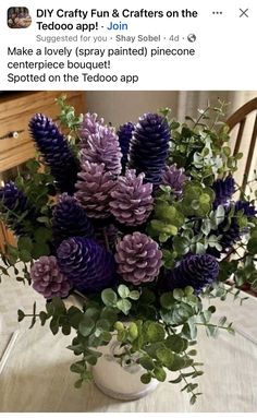 a vase filled with purple flowers on top of a table