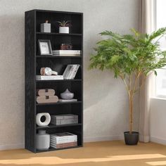 a black bookcase next to a potted plant