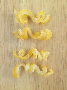 the word love spelled out with peeled orange peels on a wooden surface in front of it