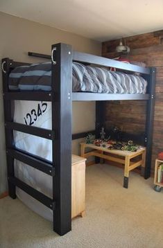 a bunk bed in a room with wooden walls and carpeted flooring on the floor