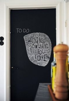 a chalkboard with words written on it in front of a door that says, to do work or what you love