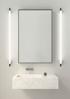 a bathroom with a sink, mirror and two lights on the wall next to it