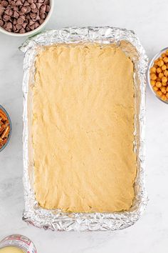 an uncooked dough in a pan with other ingredients around it