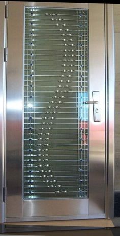 a stainless steel door with glass inserts on the front and side panels that lead into an elevator