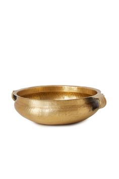 a brass bowl on a white background