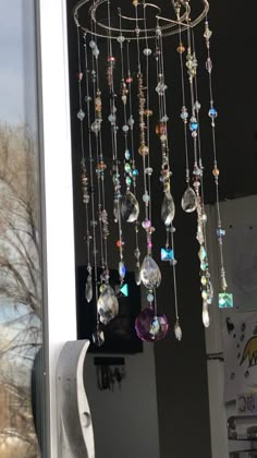 a wind chime hanging from the side of a window