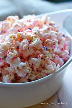 a white bowl filled with sprinkles on top of a table