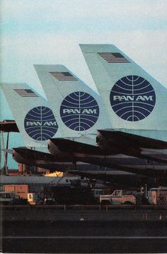 three large air planes sitting on top of an airport tarmac with the word pan am painted on them