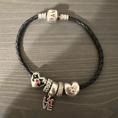 Black Pandora Black Braided Leather Bracelet. 5 Pandora X Disney Charms (All Authentic Pandora). Mickey And Minnie Kissing Charm Is Reversible And Says Believe In Magic On The Back. $500 Total Value. Nickel-free Black Charm Bracelet As Gift, Lady And The Tramp Pandora Charm, Nickel-free Black Charm Bracelet For Gift, Pandora Moments Double Black Leather Bracelet, Black Nickel-free Charm Bracelet, Pandora Black, Mickey And Minnie Kissing, Jewelry Pandora, Disney Bracelet