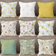 six pillows with daisies on them are lined up in rows, all different colors and sizes