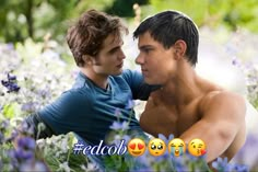 two shirtless young men sitting next to each other in the middle of purple flowers